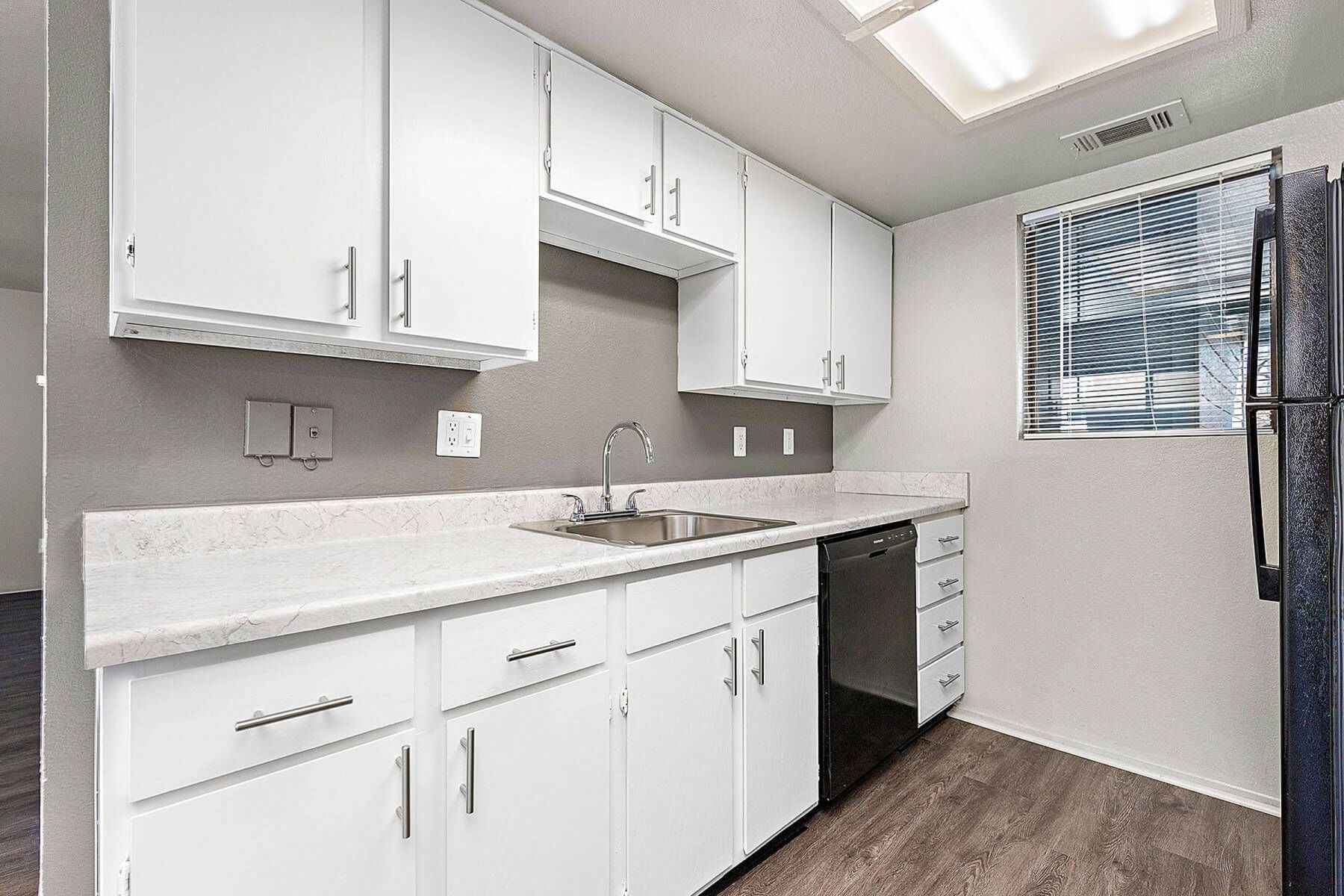 Luxury apartment kitchen with stainless steel appliances, granite countertops, and lots of storage space